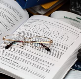 Glasses on an open text book.